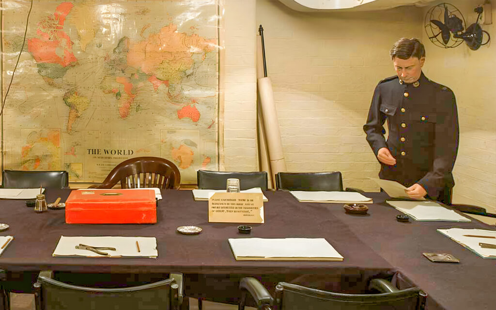 WWII war room with map, table, and man in uniform